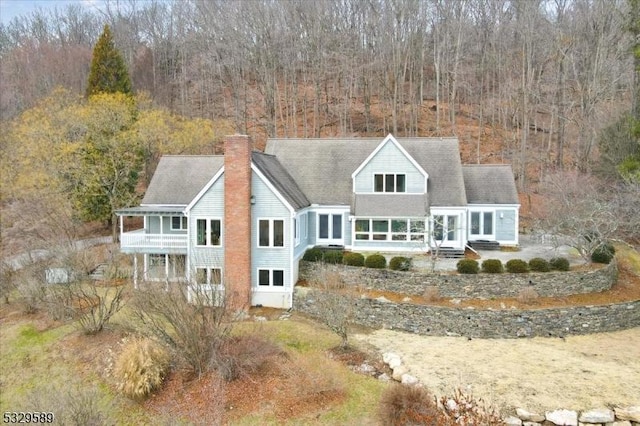 rear view of property with a balcony