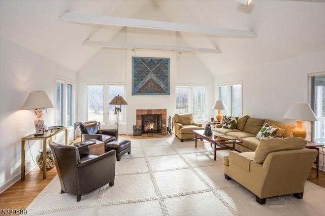 living room with hardwood / wood-style floors, beamed ceiling, and high vaulted ceiling