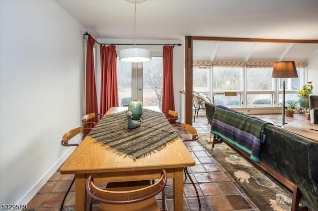 sunroom featuring beamed ceiling and plenty of natural light