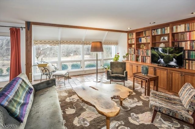 living area featuring lofted ceiling with beams and light tile patterned flooring