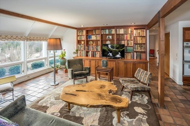 living area with tile patterned flooring and lofted ceiling with beams