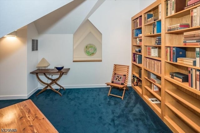 sitting room with dark colored carpet