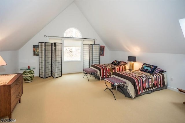 bedroom featuring light colored carpet and lofted ceiling