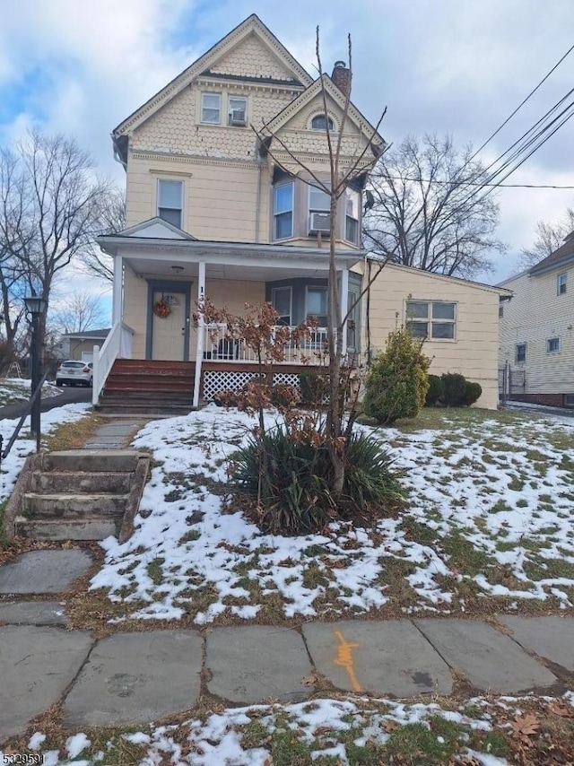 victorian-style house featuring a porch