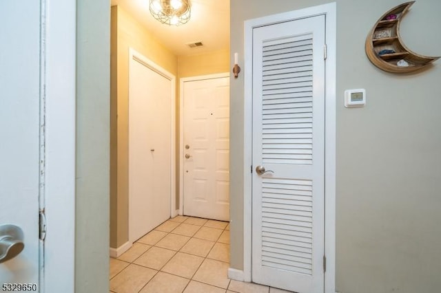 hallway featuring light tile patterned floors