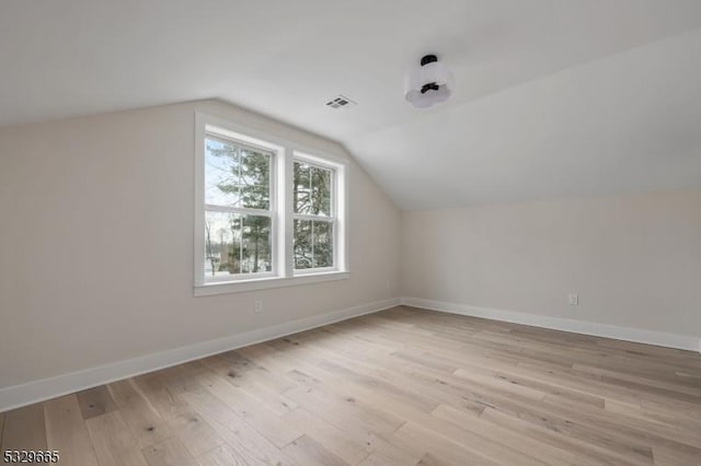 bonus room with light wood-style floors, baseboards, and visible vents