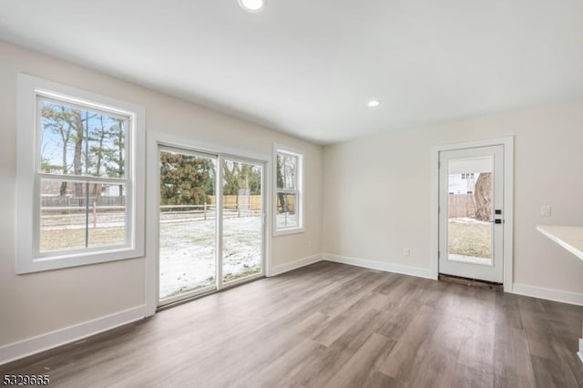 unfurnished room featuring dark wood-style floors, baseboards, and recessed lighting