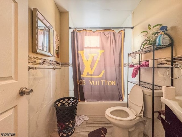 bathroom featuring shower / bath combo and toilet