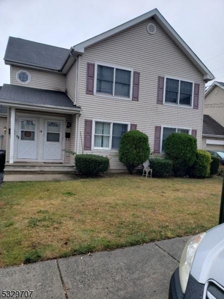 view of front of house featuring french doors and a front yard