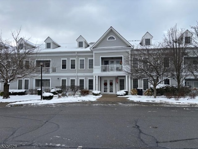 view of front facade with french doors and a balcony