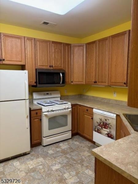 kitchen featuring white appliances and sink