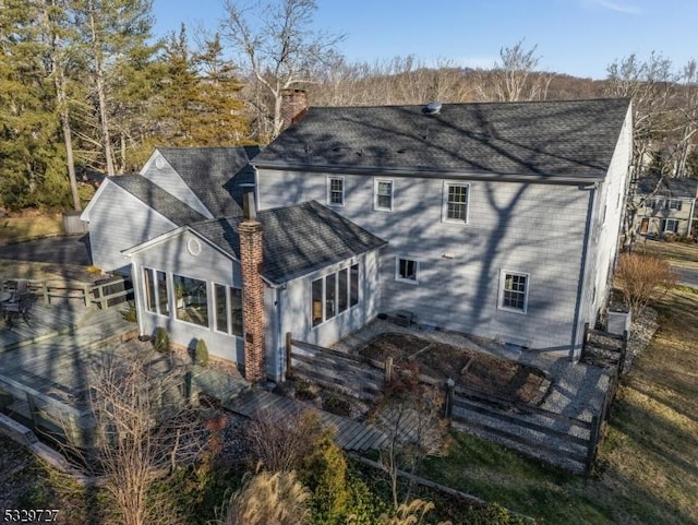 rear view of house featuring a sunroom