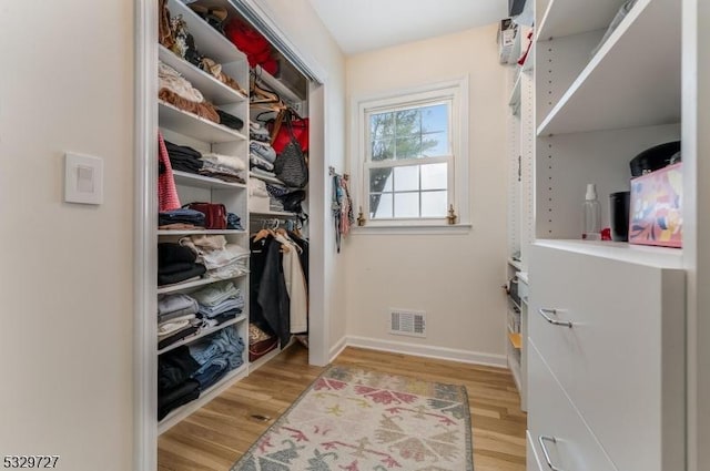 walk in closet featuring light hardwood / wood-style flooring