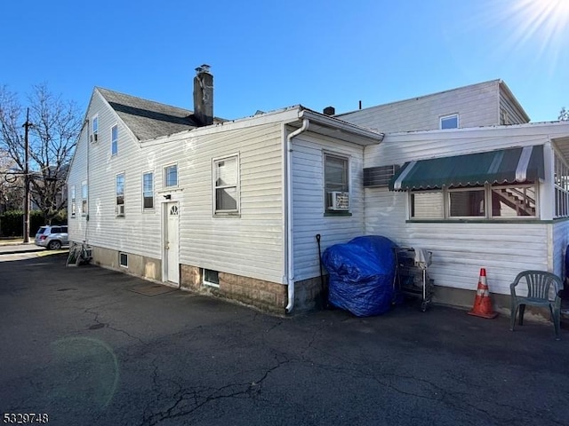 view of side of property featuring cooling unit