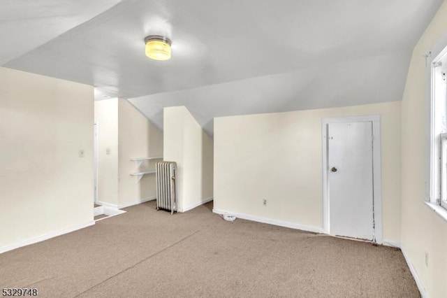 bonus room with vaulted ceiling, radiator, carpet, and baseboards