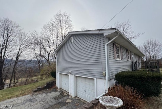 view of property exterior with a wooden deck and a garage