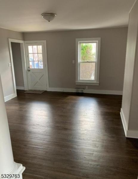 spare room with dark hardwood / wood-style floors