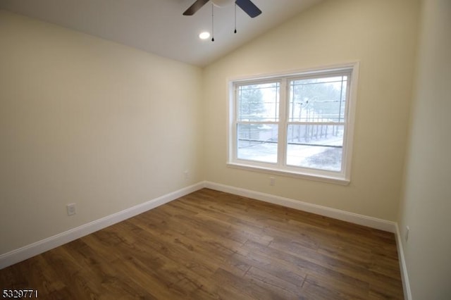 spare room featuring ceiling fan, dark hardwood / wood-style flooring, and lofted ceiling