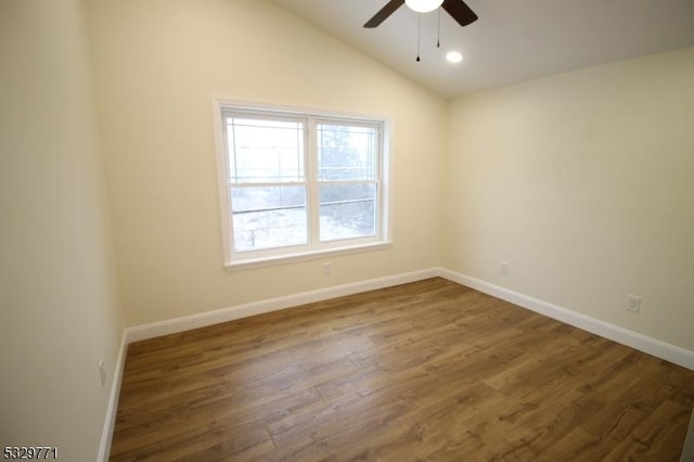 unfurnished room featuring vaulted ceiling, ceiling fan, and dark wood-type flooring