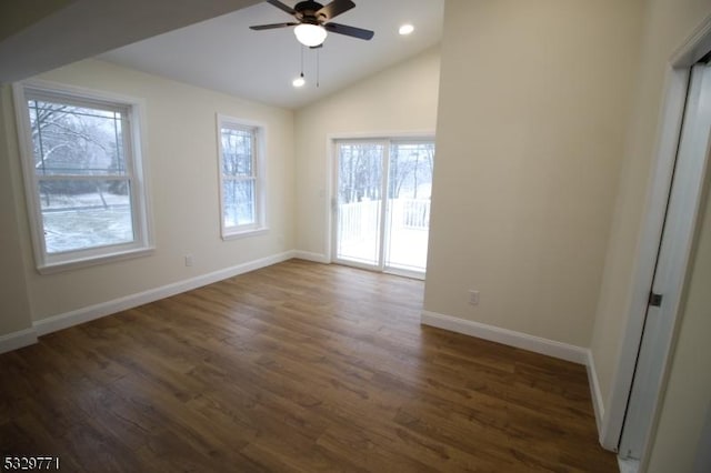 interior space with ceiling fan, dark wood-type flooring, and vaulted ceiling