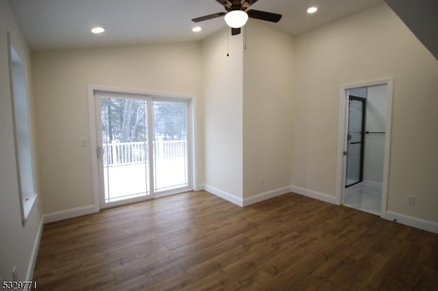 empty room featuring ceiling fan, dark wood-type flooring, and lofted ceiling