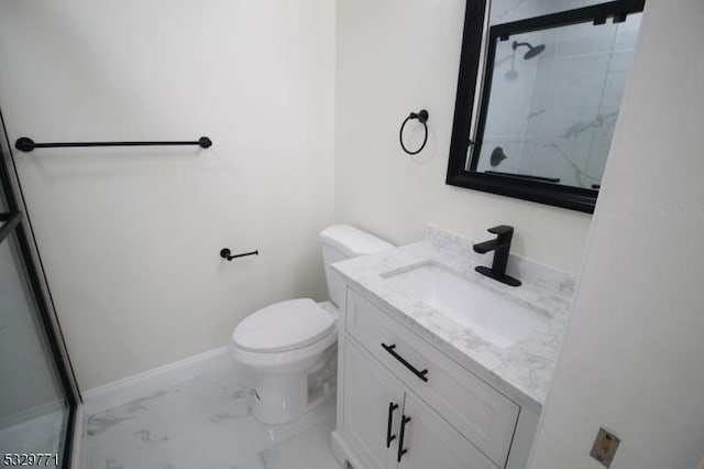 bathroom with a shower with door, vanity, and toilet