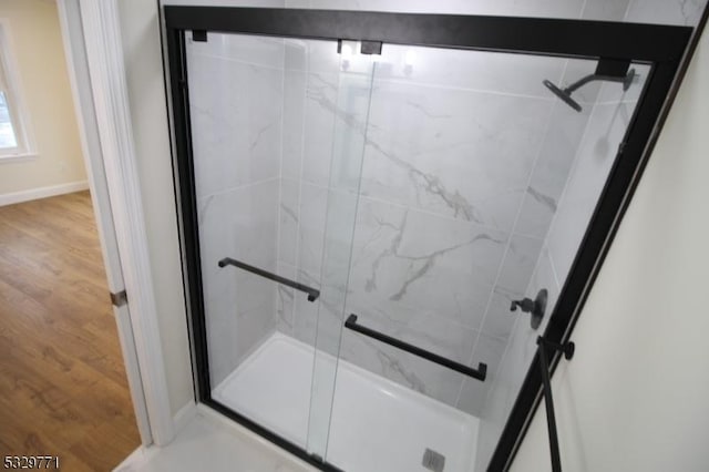 bathroom featuring a shower with shower door