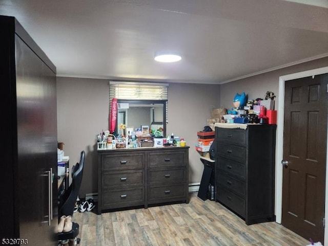 bedroom featuring crown molding and light wood-type flooring