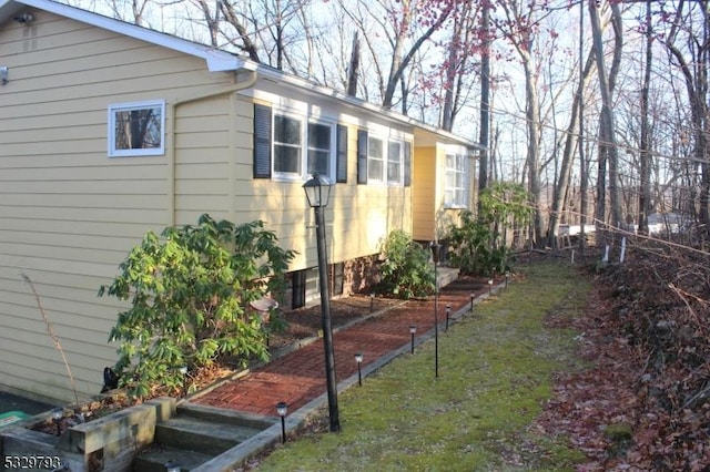 view of property exterior with a yard