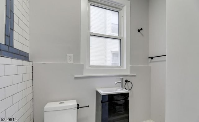 bathroom featuring vanity, toilet, and plenty of natural light