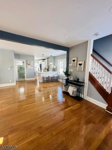 living room with hardwood / wood-style floors and beam ceiling