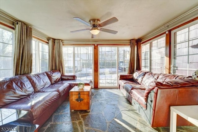 sunroom featuring ceiling fan