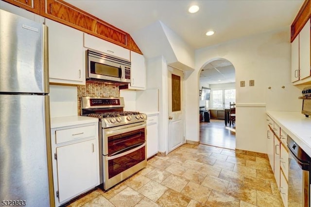 kitchen featuring white cabinets, backsplash, and stainless steel appliances