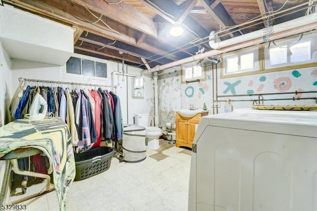 basement featuring washer / clothes dryer and sink