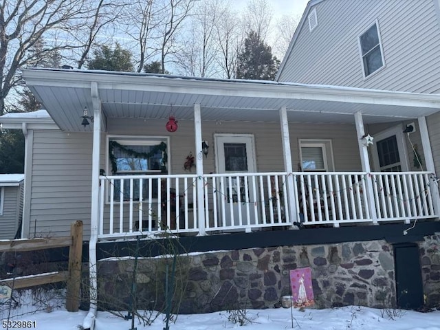 view of snowy exterior with a porch