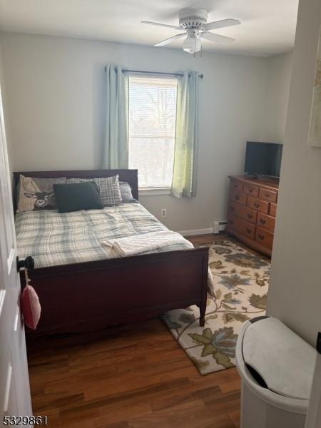 bedroom featuring dark hardwood / wood-style flooring and ceiling fan