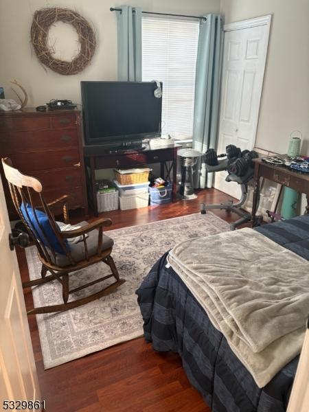 bedroom featuring a closet and dark wood-type flooring