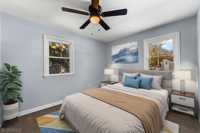 bedroom with dark hardwood / wood-style flooring and ceiling fan