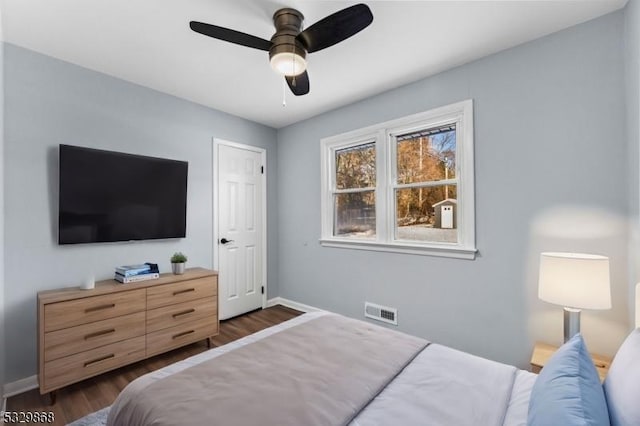 bedroom featuring ceiling fan and dark wood-type flooring