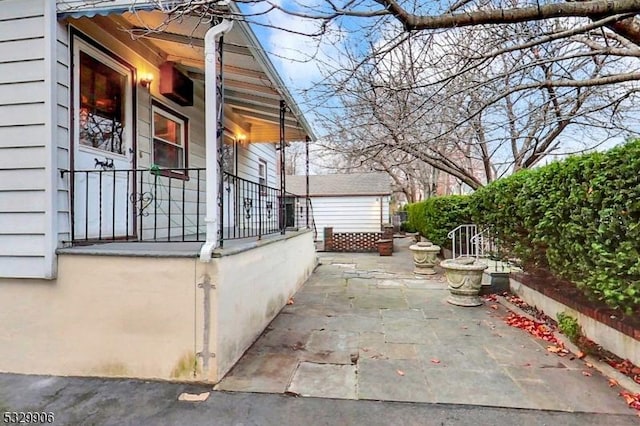 view of side of property with a patio