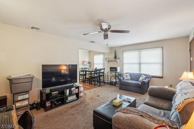 carpeted living room featuring ceiling fan