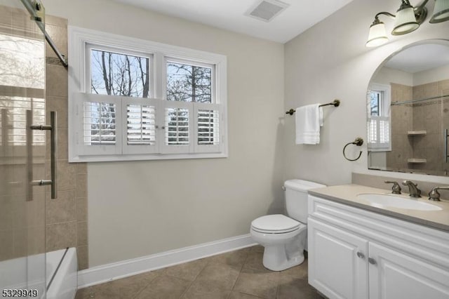 full bathroom featuring tiled shower / bath, vanity, tile patterned flooring, and a wealth of natural light