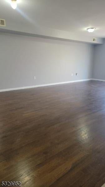 spare room with dark hardwood / wood-style flooring