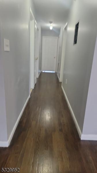 hall with dark hardwood / wood-style floors