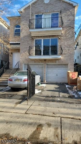 view of front property featuring a balcony and a garage