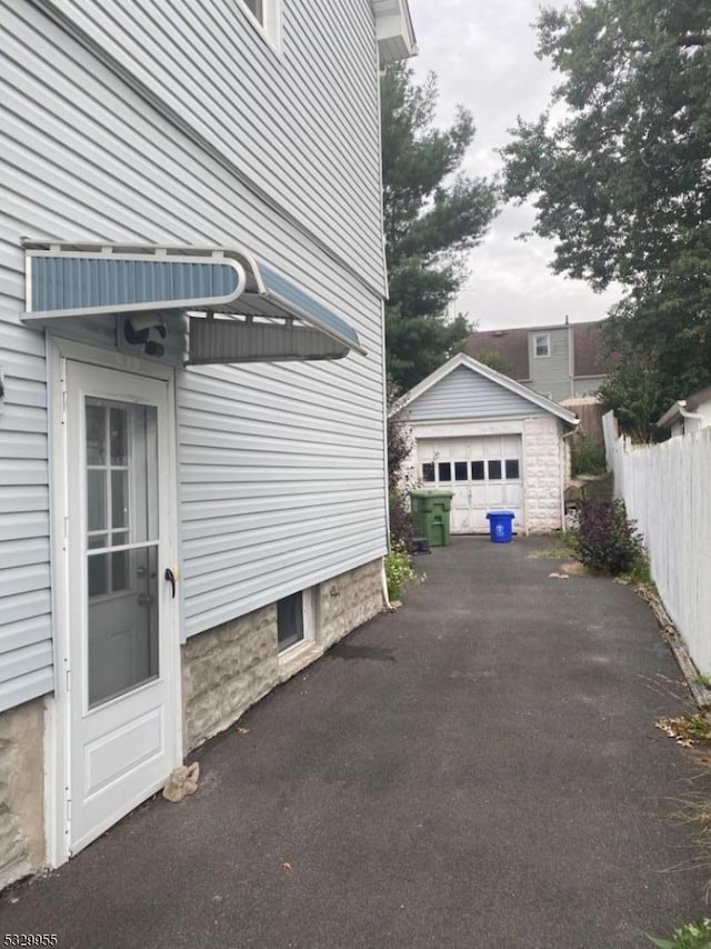 view of property exterior featuring an outbuilding and a garage