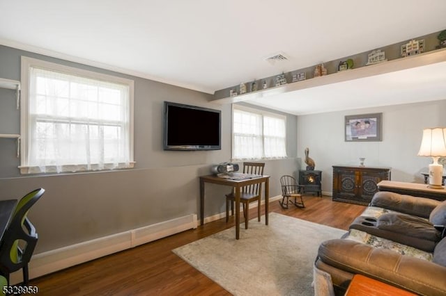 living room with dark hardwood / wood-style flooring and baseboard heating