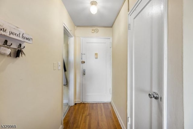 corridor with hardwood / wood-style floors