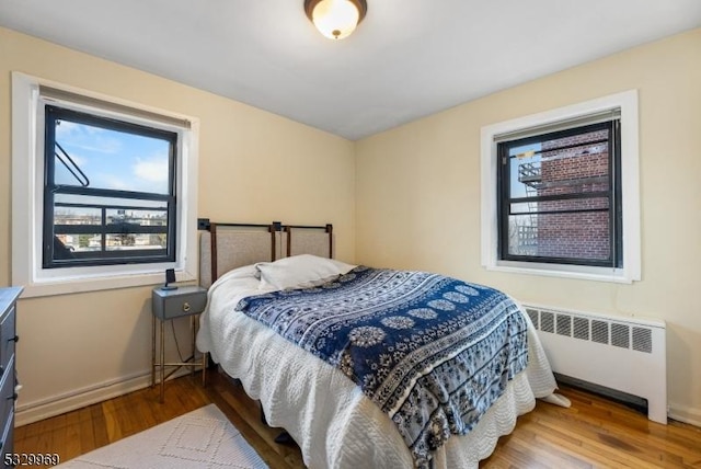 bedroom featuring radiator and light wood-type flooring