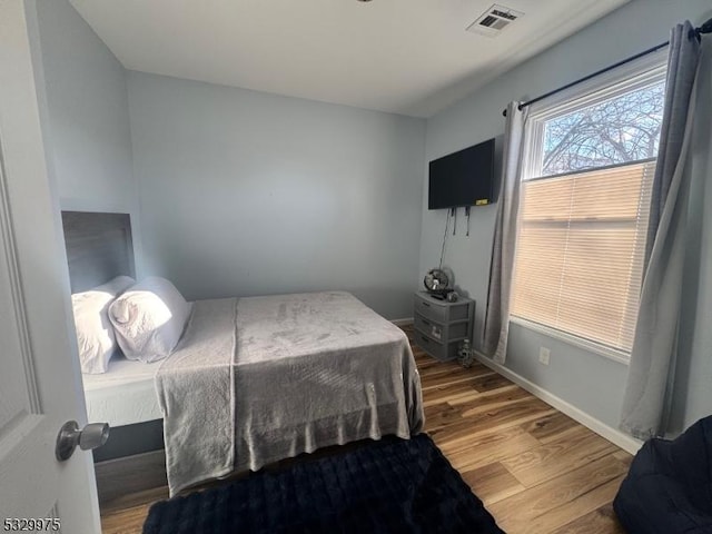 bedroom with hardwood / wood-style floors